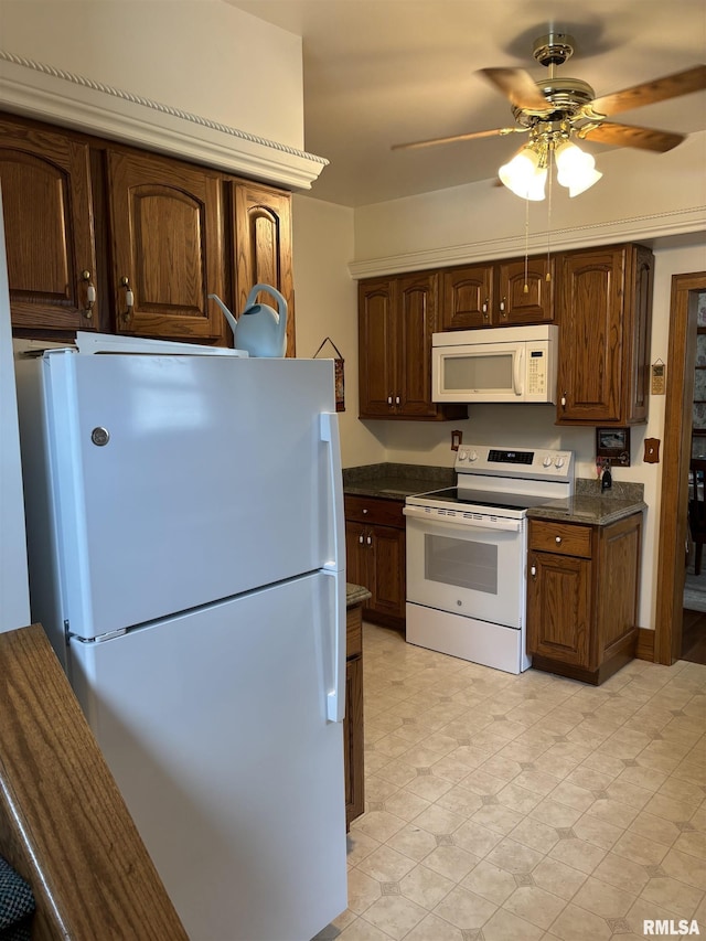 1905 S Whittier Ave, Springfield, IL 62704 - kitchen with white appliances, dark countertops, ceiling fan, and light floors