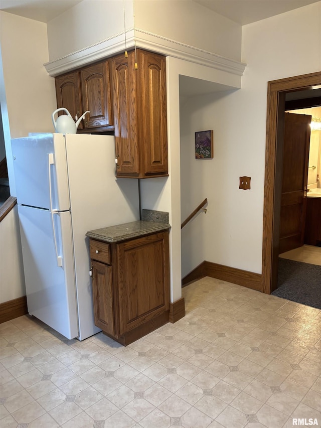 1905 S Whittier Ave, Springfield, IL 62704 - kitchen with dark stone countertops and freestanding refrigerator