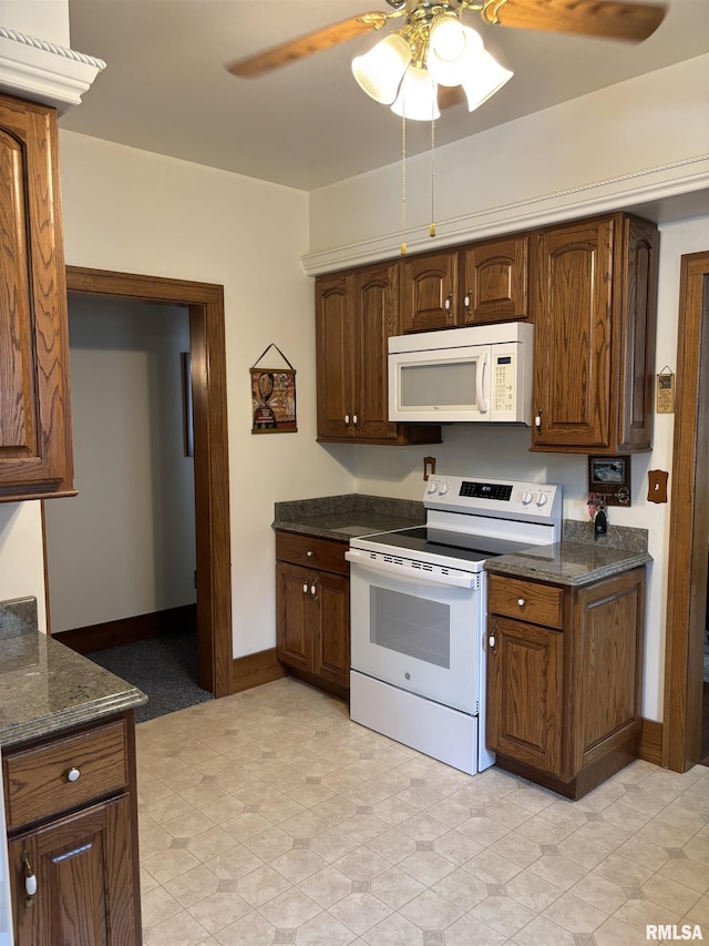 1905 S Whittier Ave, Springfield, IL 62704 - kitchen with white appliances, ceiling fan, and dark stone counters