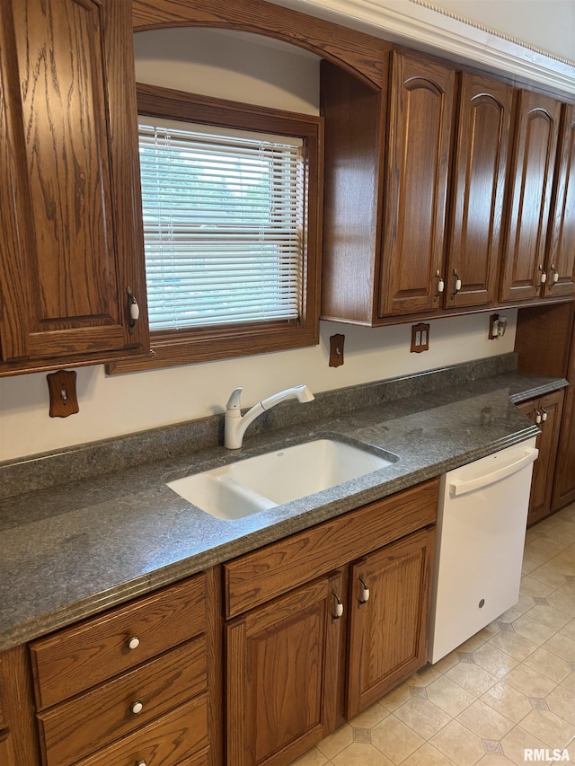 1905 S Whittier Ave, Springfield, IL 62704 - kitchen featuring dishwasher, light tile patterned floors, and brown cabinetry