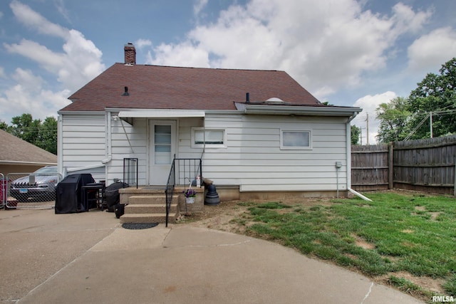 1728 Adams St, Quincy, IL 62301 - back of house featuring a chimney and concrete driveway