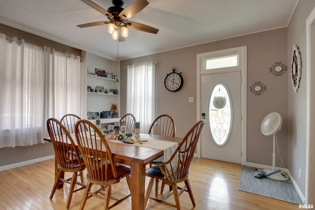 1728 Adams St, Quincy, IL 62301 - dining area featuring ceiling fan, light wood-type flooring, plenty of natural light, and ornamental molding