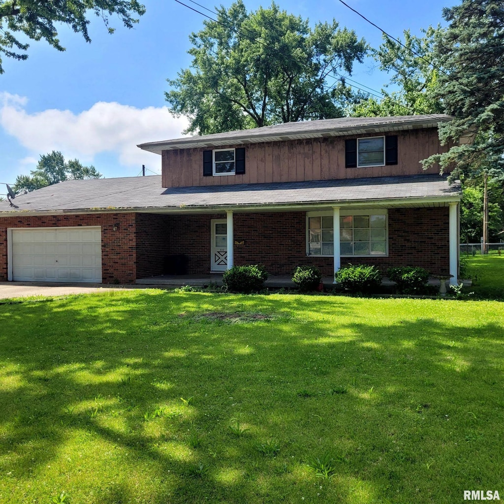 222 E Apple Orchard Rd, Springfield, IL 62703 - traditional home with a garage, a front lawn, covered porch, brick siding, and driveway