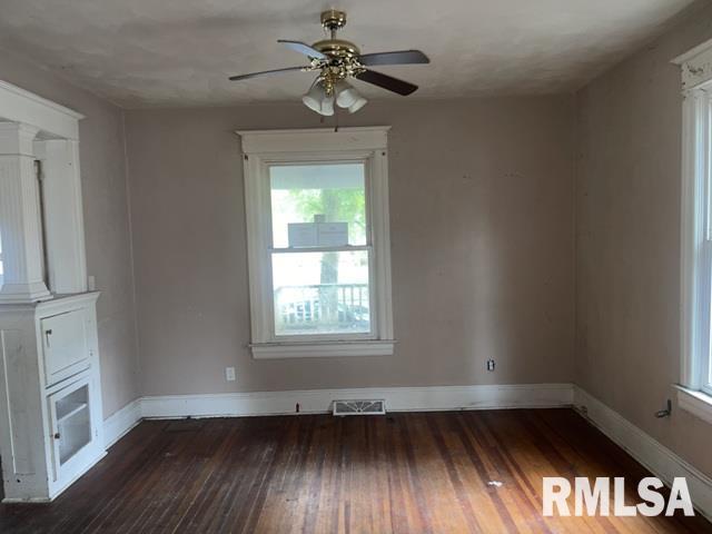 2541 S 10th St, Springfield, IL 62703 - unfurnished room with ornate columns, a ceiling fan, and hardwood / wood-style flooring