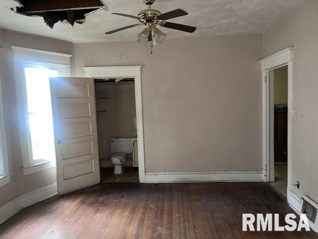 2541 S 10th St, Springfield, IL 62703 - unfurnished bedroom with multiple windows, hardwood / wood-style flooring, and a ceiling fan
