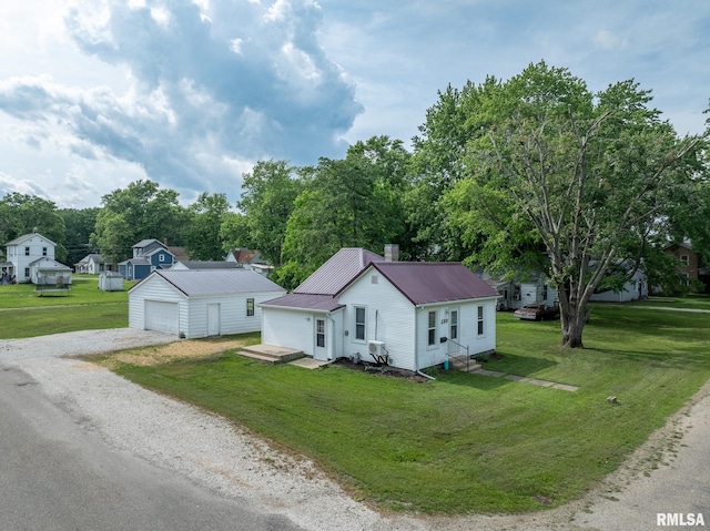100 N Austin Ave, Abingdon, IL 61410 - view of front of property featuring gravel driveway, a garage, an outdoor structure, a front yard, and a metal roof