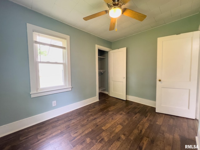 100 N Austin Ave, Abingdon, IL 61410 - unfurnished bedroom featuring dark wood-style flooring and ceiling fan