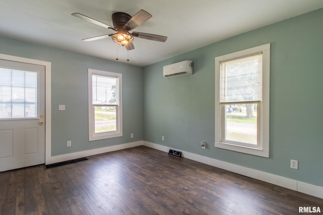 100 N Austin Ave, Abingdon, IL 61410 - unfurnished room featuring a wall unit AC, dark wood finished floors, and ceiling fan
