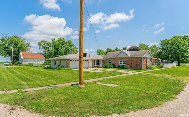 205 E Pine St, Broadwell, IL 62634 - ranch-style home with an attached garage, brick siding, driveway, and a front lawn