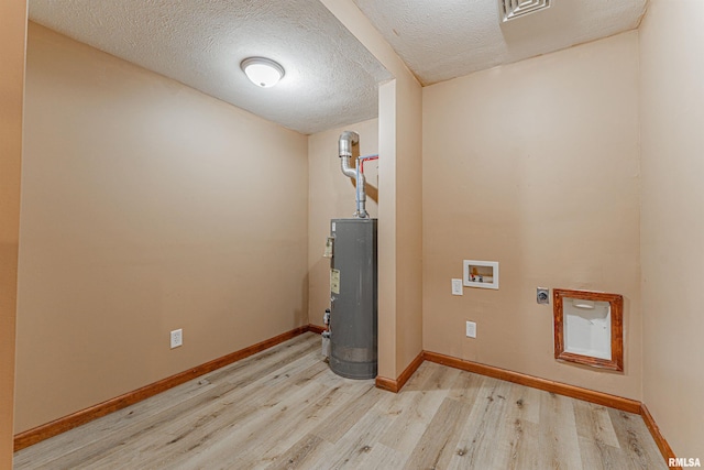 205 E Pine St, Broadwell, IL 62634 - washroom with hookup for an electric dryer, light wood-style floors, water heater, washer hookup, and a textured ceiling