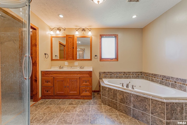205 E Pine St, Broadwell, IL 62634 - full bathroom featuring a bath, double vanity, a textured ceiling, and a stall shower