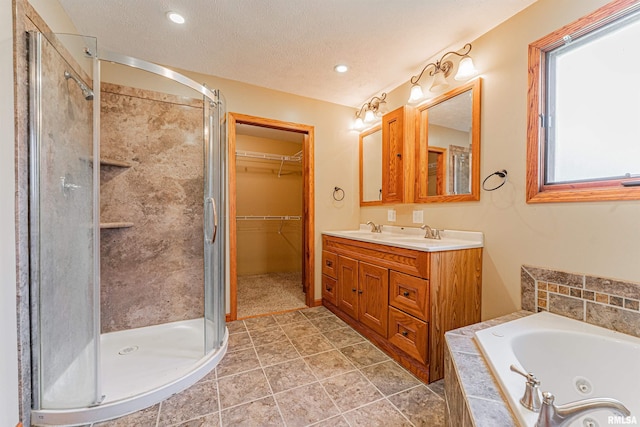 205 E Pine St, Broadwell, IL 62634 - bathroom featuring a shower stall, a tub with jets, double vanity, a textured ceiling, and recessed lighting