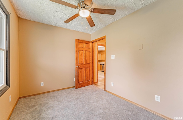 205 E Pine St, Broadwell, IL 62634 - carpeted empty room with a textured ceiling and ceiling fan