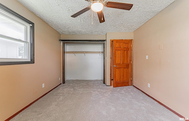 205 E Pine St, Broadwell, IL 62634 - unfurnished bedroom with a textured ceiling, carpet flooring, a closet, and ceiling fan