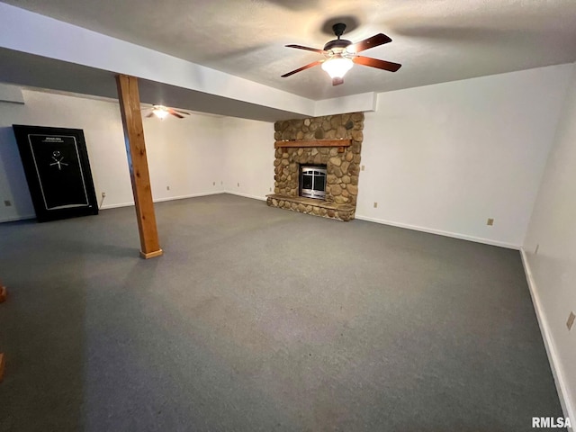 13570 Chambers Rd, Petersburg, IL 62675 - unfurnished living room featuring a ceiling fan, a stone fireplace, and dark carpet