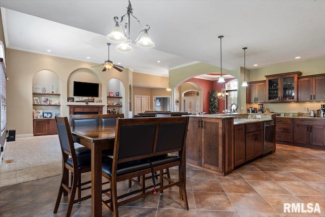 5408 Cromwell Pl, Springfield, IL 62711 - kitchen featuring stainless steel dishwasher, open floor plan, arched walkways, a ceiling fan, and ornamental molding