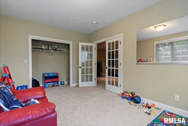 5408 Cromwell Pl, Springfield, IL 62711 - living area featuring french doors, carpet flooring, and a textured ceiling