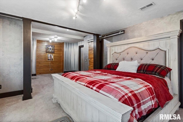 5408 Cromwell Pl, Springfield, IL 62711 - bedroom featuring light colored carpet, wooden walls, rail lighting, and a textured ceiling