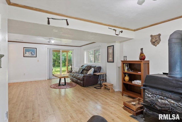 2 Mesa Rd, Springfield, IL 62702 - living room with ornamental molding, a wood stove, and light wood-style floors
