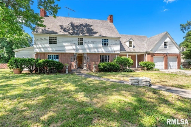 421 W Jackson Pkwy, Springfield, IL 62704 - view of front of home with brick siding, a front lawn, a chimney, and a garage