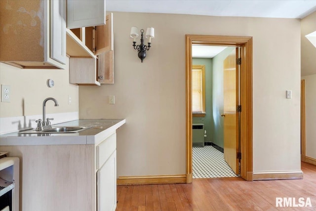 421 W Jackson Pkwy, Springfield, IL 62704 - kitchen featuring light wood finished floors, light countertops, and radiator heating unit