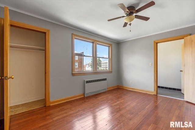 421 W Jackson Pkwy, Springfield, IL 62704 - unfurnished bedroom featuring radiator, hardwood / wood-style flooring, ornamental molding, a closet, and ceiling fan