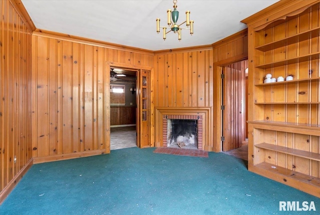 421 W Jackson Pkwy, Springfield, IL 62704 - unfurnished living room featuring ornamental molding, wood walls, carpet, a chandelier, and a brick fireplace