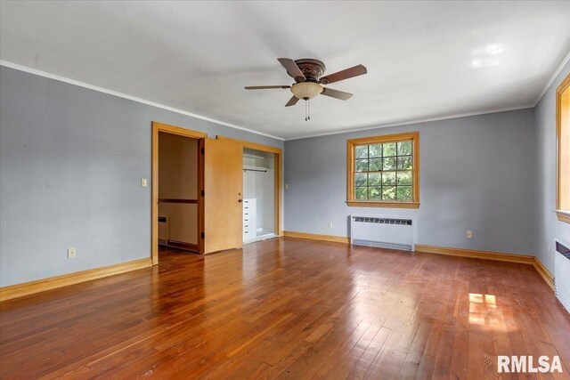 421 W Jackson Pkwy, Springfield, IL 62704 - unfurnished bedroom featuring radiator heating unit, ornamental molding, wood-type flooring, and a ceiling fan