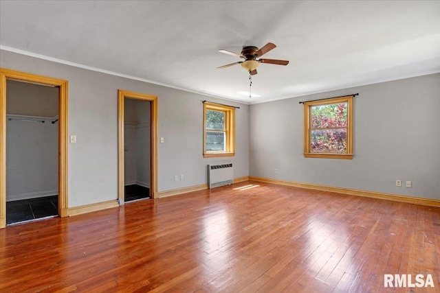 421 W Jackson Pkwy, Springfield, IL 62704 - unfurnished bedroom featuring radiator, hardwood / wood-style flooring, a walk in closet, crown molding, and ceiling fan