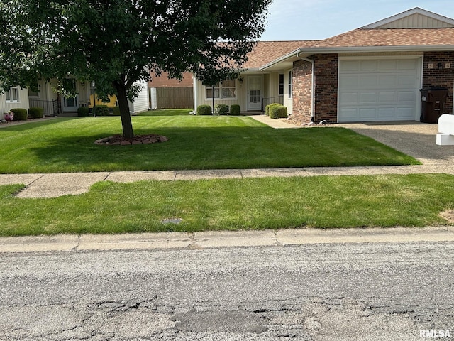 100 E Heights Ave, Taylorville, IL 62568 - view of front of house featuring a garage, brick siding, driveway, a front lawn, and roof with shingles