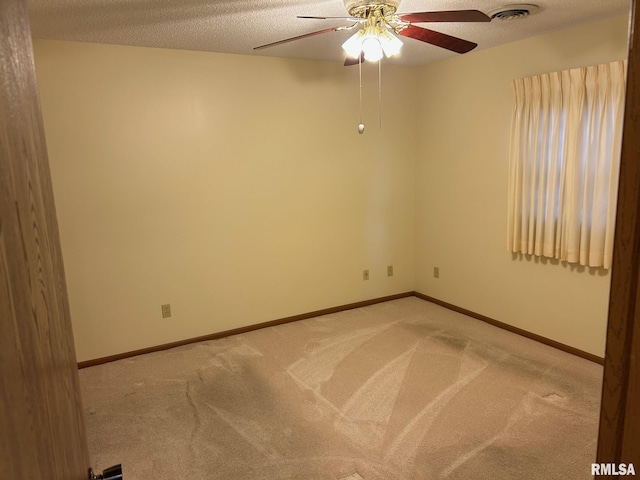 100 E Heights Ave, Taylorville, IL 62568 - spare room with ceiling fan, light carpet, and a textured ceiling