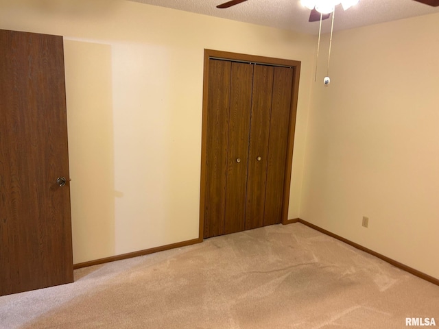 100 E Heights Ave, Taylorville, IL 62568 - unfurnished bedroom with light colored carpet, a closet, and ceiling fan