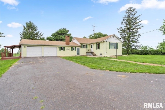 240 Mine Ave, Girard, IL 62640 - ranch-style home featuring an attached garage, a chimney, asphalt driveway, and a front yard