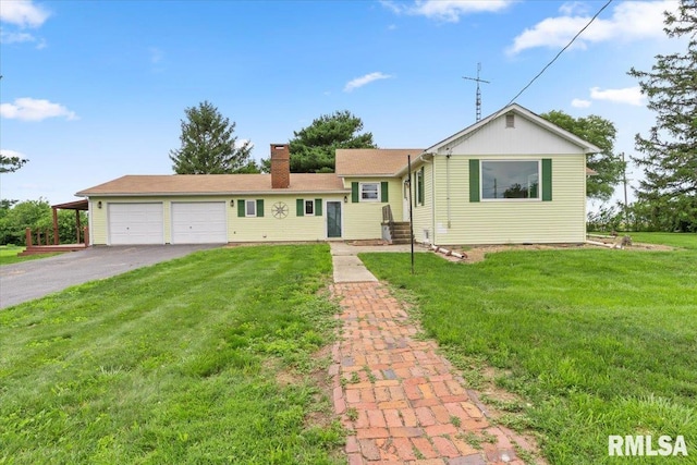 240 Mine Ave, Girard, IL 62640 - view of front of house with a chimney, driveway, a garage, and a front lawn