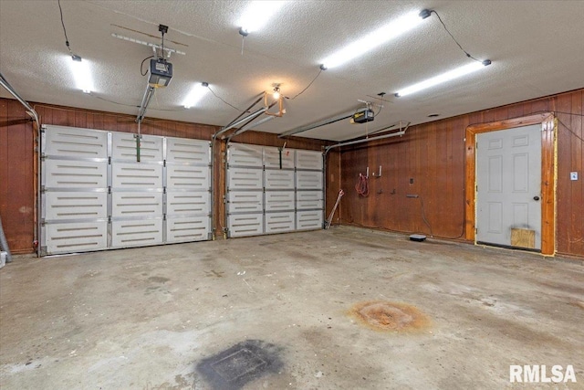 240 Mine Ave, Girard, IL 62640 - garage featuring a garage door opener and wood walls