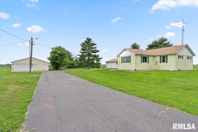 240 Mine Ave, Girard, IL 62640 - ranch-style home featuring a garage, a front lawn, and an outdoor structure