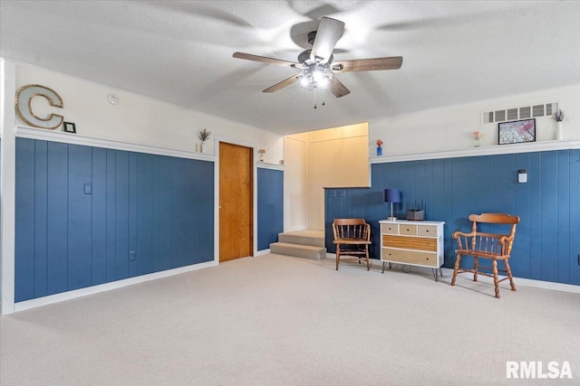 240 Mine Ave, Girard, IL 62640 - sitting room with ceiling fan, carpet flooring, and wooden walls
