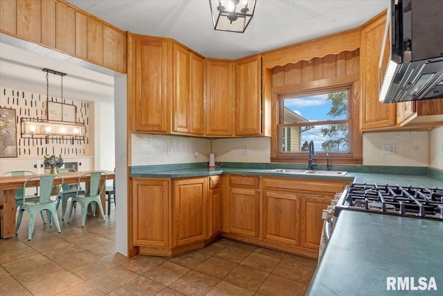 240 Mine Ave, Girard, IL 62640 - kitchen featuring stainless steel microwave, decorative light fixtures, light tile patterned floors, and brown cabinets