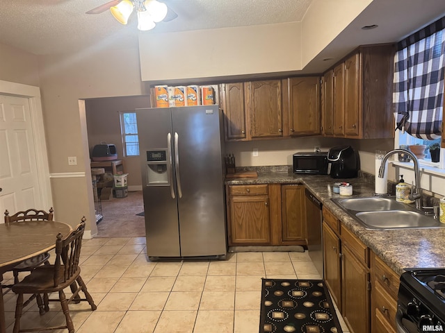 1238 N 12th St, Quincy, IL 62301 - kitchen featuring black appliances, ceiling fan, dark countertops, light tile patterned floors, and a textured ceiling