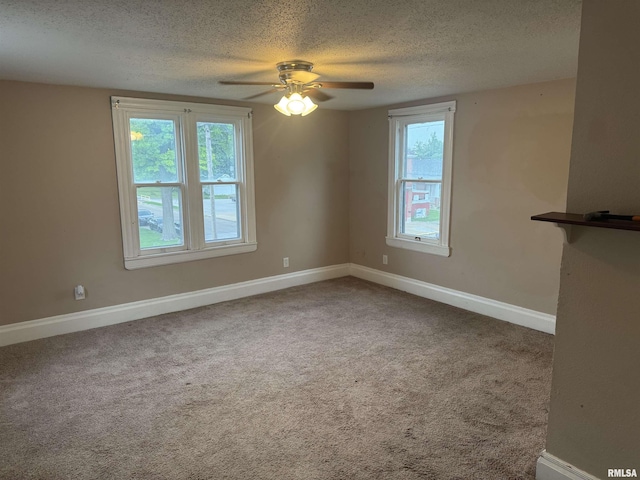 1238 N 12th St, Quincy, IL 62301 - empty room with a textured ceiling, a ceiling fan, healthy amount of natural light, and carpet floors