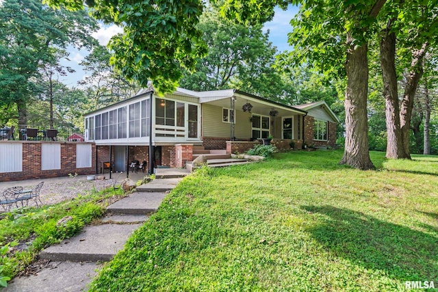 1847 New Salem Church Rd, New Berlin, IL 62670 - view of front facade with a sunroom, a front lawn, and brick siding