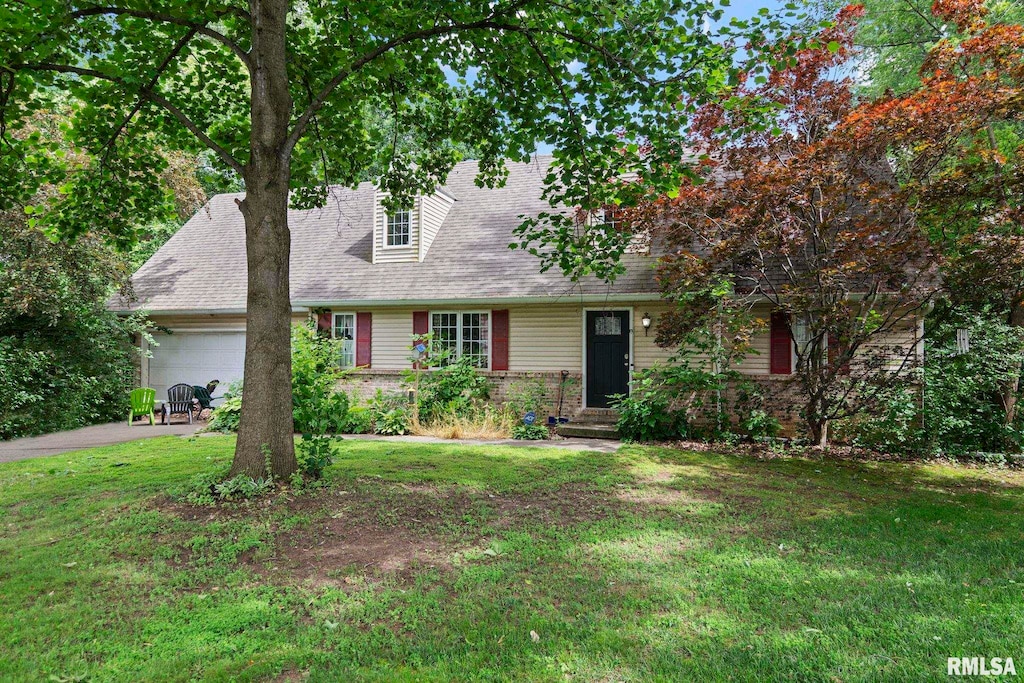 14 Willow Hill Dr, Sherman, IL 62684 - cape cod-style house featuring an attached garage, a front yard, driveway, and roof with shingles
