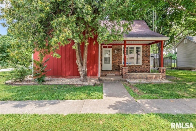 209 W Madison St, Athens, IL 62613 - view of front of home featuring a front lawn, brick siding, and roof with shingles