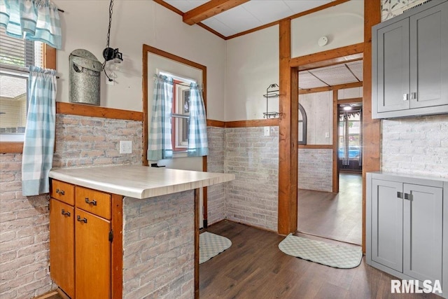 209 W Madison St, Athens, IL 62613 - kitchen featuring healthy amount of natural light, beamed ceiling, wood finished floors, brick wall, and light countertops
