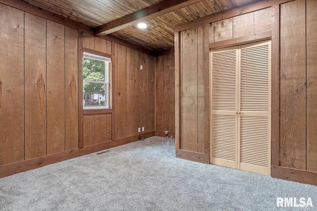 209 W Madison St, Athens, IL 62613 - unfurnished bedroom with wooden walls, carpet floors, and a wood ceiling with exposed beams