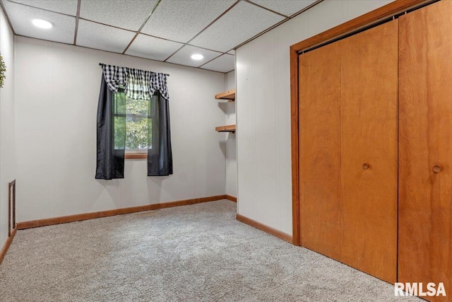 209 W Madison St, Athens, IL 62613 - unfurnished bedroom featuring carpet floors, a closet, and a paneled ceiling