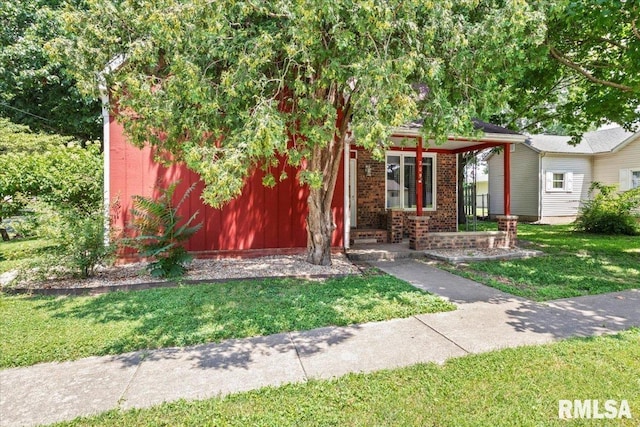 209 W Madison St, Athens, IL 62613 - obstructed view of property featuring a front yard and brick siding