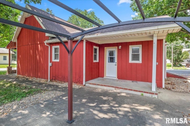 209 W Madison St, Athens, IL 62613 - entrance to property featuring roof with shingles and board and batten siding