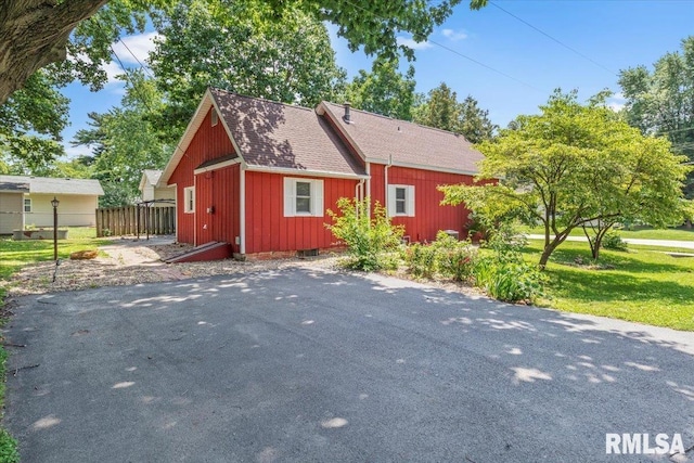 209 W Madison St, Athens, IL 62613 - view of side of home with a shingled roof and board and batten siding