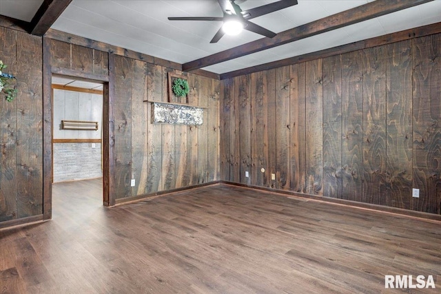 209 W Madison St, Athens, IL 62613 - empty room with beam ceiling, wooden walls, wood finished floors, and ceiling fan
